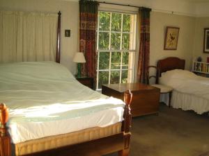 A bed or beds in a room at Bulmer Tye House 