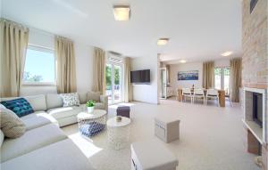 a living room with a couch and a fireplace at Amazing Home In Martinscica in Martinšćica