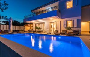 a swimming pool in front of a house at night at Amazing Home In Martinscica in Martinšćica +54 photos