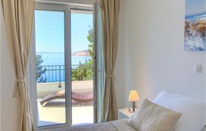 a bedroom with a bed and a view of the ocean at Amazing Home In Martinscica in Martinšćica
