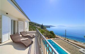 a balcony with two chairs and a view of the ocean at Amazing Home In Martinscica in Martinšćica