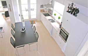 a dining room with a black table and chairs at 3 Bedroom Beautiful Home In Nysted in Nysted