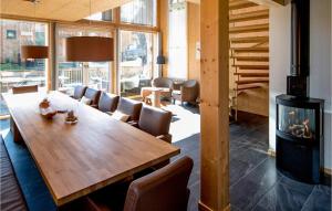 a dining room with a table and a fireplace at Stunning Home In St,georgen A,kreischb, With 5 Bedrooms And Sauna in Sankt Lorenzen ob Murau