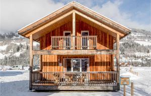 a log cabin with a balcony in the snow at Stunning Home In St,georgen Am Kreischb, With 2 Bedrooms And Sauna in Sankt Lorenzen ob Murau