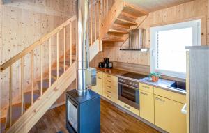 a kitchen with a stove in a wooden house at Stunning Home In St,georgen Am Kreischb, With 2 Bedrooms And Sauna in Sankt Lorenzen ob Murau