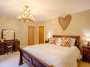 a bedroom with a bed with a heart on the wall at The Haven - Uk38739 in Barlow