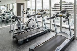 a row of cardio machines in a gym at Two bedroom apartment on Ann Street Fortitude Valley By Serain Residences in Brisbane
