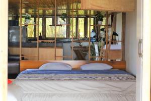 a bed with two pillows in a room at Room Papagayo - Ayampe in Ayampe