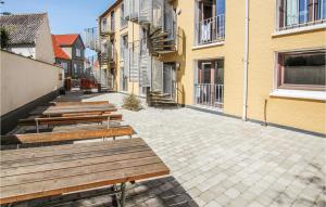 a row of wooden benches sitting on a street at Lovely Apartment In Samsø in Ballen +10 photos