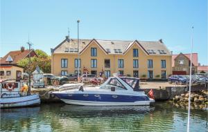 two boats docked in a marina in front of a building at Cozy Apartment In Sams With House Sea View in Ballen