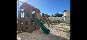 un parque infantil con un tobogán en un patio en Beautiful Condo in La Romana with pool near Caleta Beach en La Romana