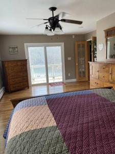 a bedroom with a bed and a ceiling fan at Lakehouse with Hot Tub close to Ark Encounter in Corinth