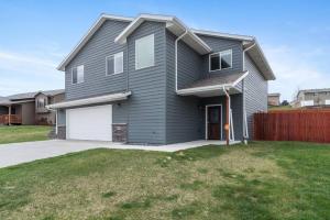 a gray house with a white garage at Large Home in the Most Convenient Location in Rapid City