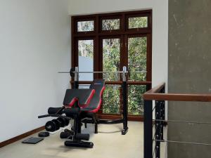 a gym with a chair in front of a window at Villa Ema in Galle