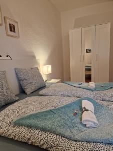 a bedroom with two beds with towels on them at Bastis City Rooms in Lucerne