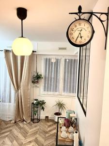 a clock hanging from a wall in a room at COTON Industriel Proche Gare et Centre in Melun