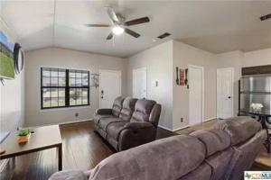 a living room with a couch and a ceiling fan at Cozy 3bd/2bath staycation near fort hood in Killeen