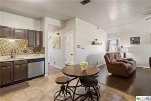 a kitchen and living room with a table and a couch at Cozy 3bd/2bath staycation near fort hood in Killeen