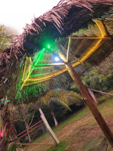 a green light on top of a thatched roof at RECANTO DO SABIÁ in Carolina