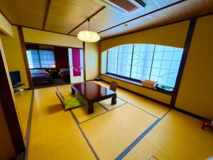 a living room with a table and a couch at Japanese style hotel Morigen in Kyotango