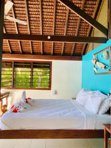 a bedroom with a bed in a room with windows at Freshwater Private Resort in Luganville