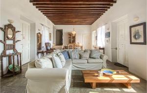 a living room with a couch and a table at Stunning Home In Sifnos With House Sea View in Sifnos