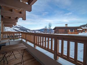 a wooden balcony with a bench and a house at Appartement Valmorel, 3 pièces, 7 personnes - FR-1-356-414 in Valmorel