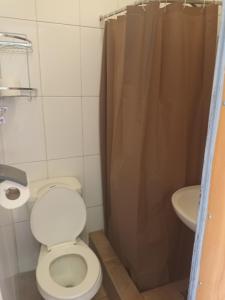 a bathroom with a toilet and a sink at Casa R in Calama