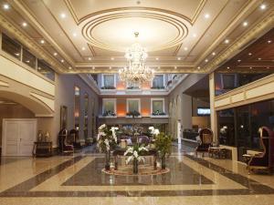 a lobby with a chandelier and a table with flowers at Euro Park Otel in Istanbul