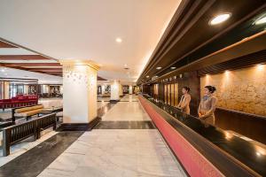 two people walking down a hallway in a building at Mountain Beach Resort & Convention Center in Pattaya South +46 photos