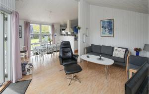 a living room with a couch and a table at Amazing Home In Sams With House Sea View in Onsbjerg