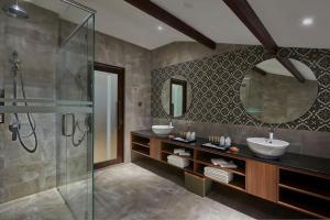 a bathroom with two sinks and a glass shower at Baba House Melaka in Melaka