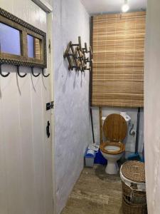a bathroom with a toilet and a window and a door at BlueMoon Studio on the Beach! in Trou dʼ Eau Douce