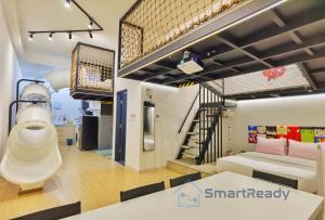 a room with a bunk bed and a staircase at Sunway GRID by SR Home in Kampong Pendas