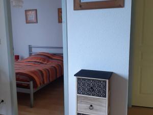 a bedroom with a bed and a dresser next to it at Appartement Cauterets, 3 pièces, 4 personnes - FR-1-234-296 in Cauterets