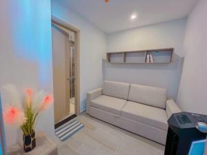 a small living room with a couch and a window at THE SONG HAPPY HOME VUNG TAU 5 STAR APARTMENT (CĂN HỘ BIỂN) in Vung Tau