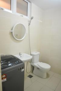 a bathroom with a toilet and a sink and a mirror at AZFA Duplex Suite at De Centrum Putrajaya Bangi FREE WIFI in Kajang
