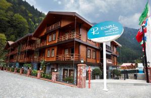 a sign in front of a large wooden building at Royal Uzungol Hotel&Spa in Uzungöl