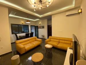 a living room with a couch and a table at FIRST RESIDENCE KRIBI in Kribi