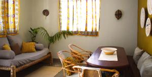 a living room with a table and a couch at Maryam Garden Apartments & Villa in Bwejuu