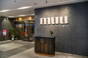 a lobby with a munit sign on a wall at MUU Bangkok Hotel in Bangkok