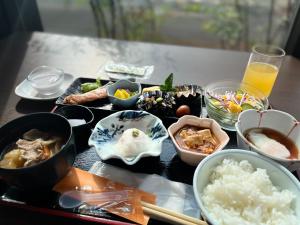 a table topped with dishes of food and drinks at APA Hotel Joetsu Myoko-Ekimae in Joetsu