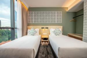 Кровать или кровати в номере Santa Grand Signature Kuala Lumpur