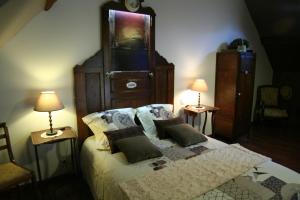 a bedroom with a large bed with two night stands at Chambre d'Hôtes du Domaine de la Haute Poignandiere in Saint-Germain-de-la-Coudre