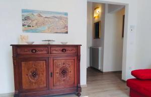 a wooden cabinet in a room with a painting on the wall at Francarooms in Florence