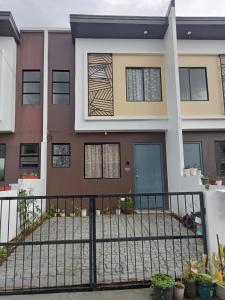 a house with a fence in front of it at Phirst Park Homes Townhouse in Lipa