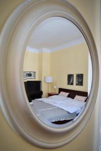 a bedroom with a bed and a mirror at Family Apartment Písek City Centre II. in Písek