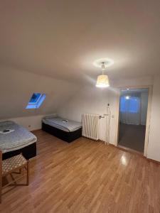 an empty room with two beds and a window at Siegen Achenbach 3 in Siegen