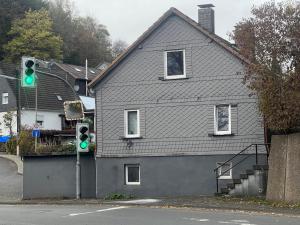 a green traffic light in front of a house at Siegen Achenbach 3 in Siegen