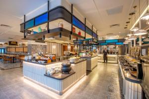 a large kitchen with a buffet in a restaurant at Santa Grand Signature Kuala Lumpur in Kuala Lumpur